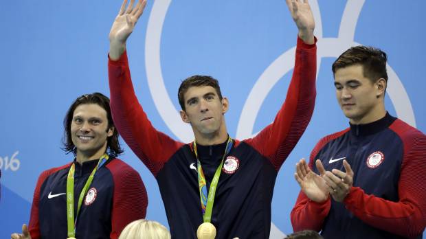 Michael Phelps waves from the podium after the U.S. team’s victory in the Olympic men’s 4 x 100-meter medley relay on Saturday in Rio de Janeiro. Phelps signs off with 23rd gold as U.S. wins 4x100 medley relay