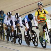 Cyclists follow Rio Olympic volunteer Ivo Siebert on the electric bike at the start of a women’s keirin first-round race in Rio de Janeiro on Friday. Rio volunteer setting the pace for keirin cyclists