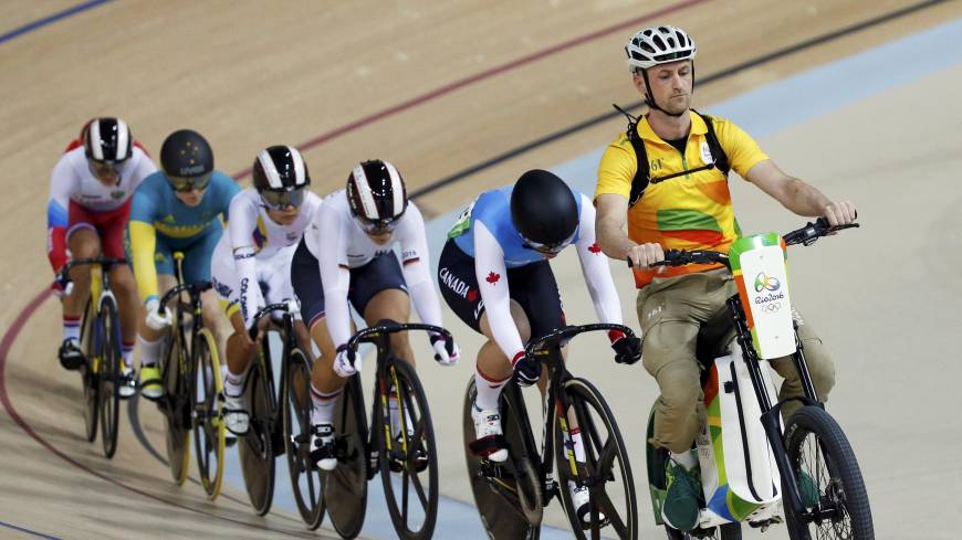 Cyclists follow Rio Olympic volunteer Ivo Siebert on the electric bike at the start of a women’s keirin first-round race in Rio de Janeiro on Friday. Rio volunteer setting the pace for keirin cyclists