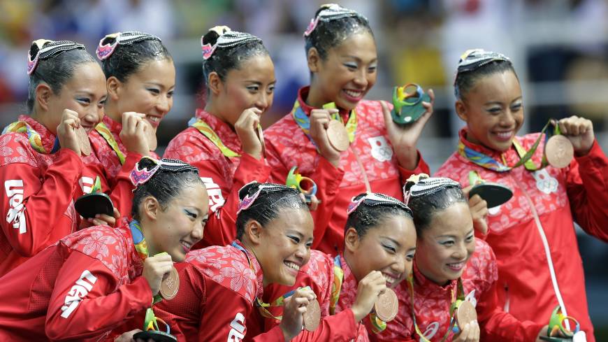 Japan team members pose with their bronze medals following the synchronized swimming team free routine final on Friday. Japan nabs bronze in team synchro
