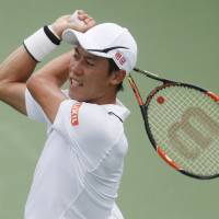 Kei Nishikori hits a return during his match against Mikhail Youzhny on Tuesday in Cincinnati. | AP