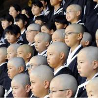 Children attend a ceremony to become Buddhist monks at Higashi Honganji Temple in the ancient capital Kyoto on Thursday. Around 140 children who are on their summer break gathered for the ceremony from around the nation. | KYODO