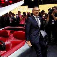 Carlos Ghosn, chairman and CEO of the Renault-Nissan Alliance, poses at a news conference on media day at the Paris auto show in France on Thursday. | REUTERS