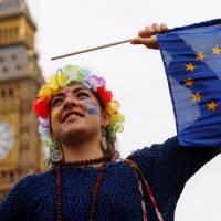 A pro-Europe demonstrator waves a flag in London on Saturday during a March for Europe protest against Britain\'s decision in June to exit the European Union. Japan has warned that the decision could prompt Japanese financial institutions to relocate from London. | REUTERS