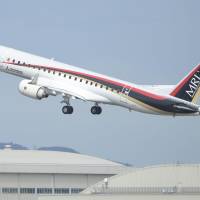 A Mitsubishi Regional Jet takes off from Nagoya Airport on Monday. | KYODO