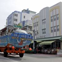 A tourist bus drives by Ocean Drive Thursday in the South Beach area of Miami Beach, Florida. Authorities in Florida said Thursday they have found the Zika virus in three groups of trapped mosquitoes in Miami Beach, the first time this has happened in the continental U.S. U.S. agency helps fund Takeda effort to develop Zika vaccine
