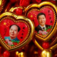 Souvenirs featuring portraits of China’s late Chairman Mao Zedong and current President Xi Jinping are seen at a shop near the Forbidden City in Beijing on Sept. 9. | REUTERS