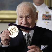 Actor, comedian and writer, Mel Brooks holds up his 2015 National Medal of Arts awarded to him by President Barack Obama during a ceremony in the East Room of the White House Thursday. With levity, Obama awards arts medals to Mel Brooks, Audra McDonald, Berry Gordy