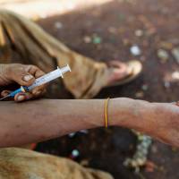 A man injects heroin into his arm along a street in Man Sam, northern Shan state, Myanmar, July 11. | REUTERS