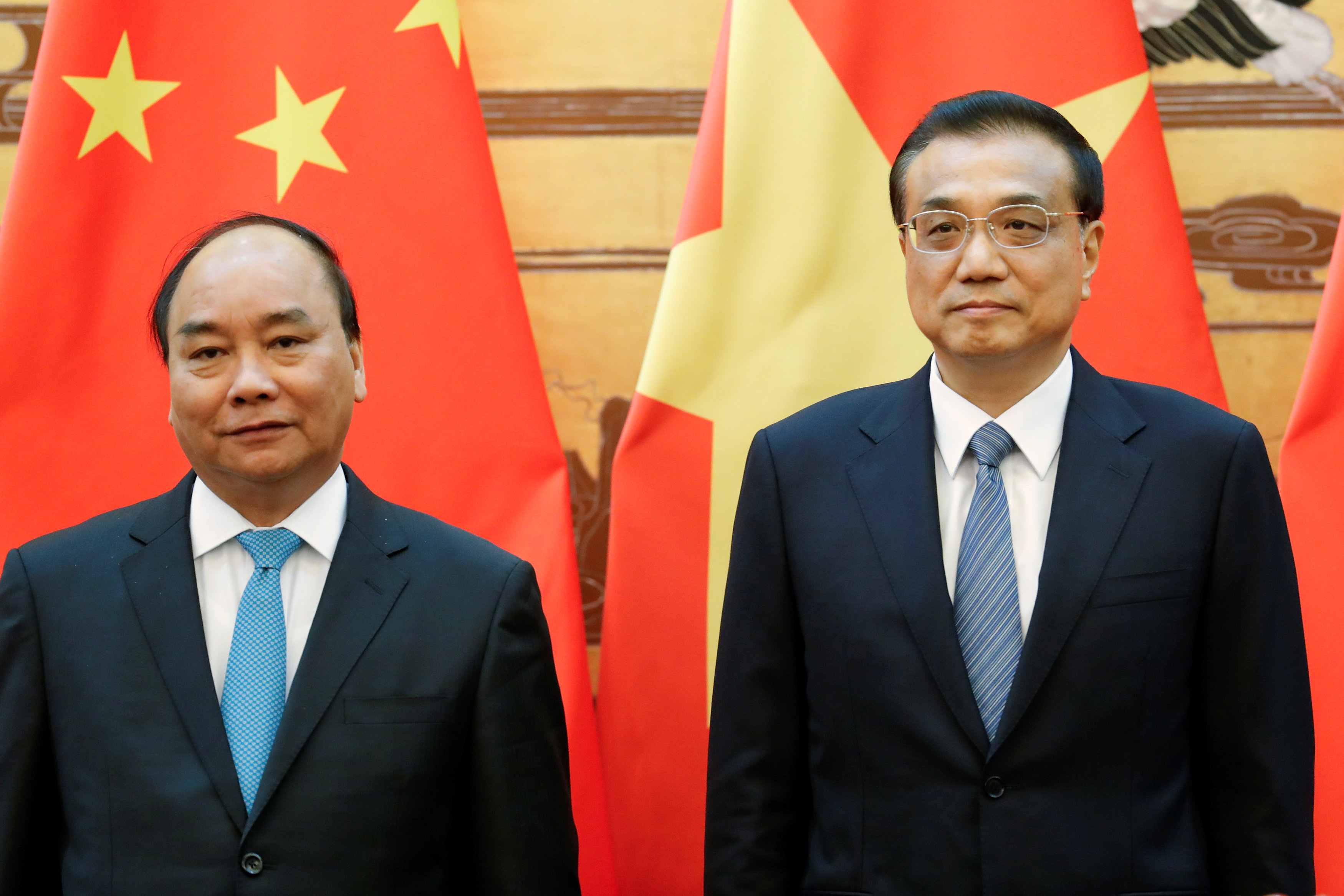Chinese Premier Li Keqiang (right) and Vietnamese Prime Minister Nguyen Xuan Phuc attend a signing ceremony at the Great Hall of the People in Beijing on Tuesday. | REUTERS