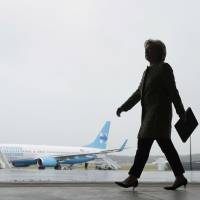 Democratic U.S. presidential candidate Hillary Clinton walks to a podium to speak with members of the media at Westchester County Airport in White Plains, New York, on Monday. | AP