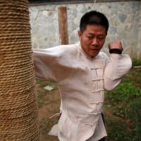 Kung fu master Xing Xi is seen practicing at his academy in Beijing on June 29. | REUTERS