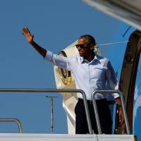 U.S. President Barack Obama on Wednesday boards Air Force One at Reno-Tahoe International Airport in Reno, Nevada, to depart for Hawaii, on his way to tour Midway Atoll and attend summits in Laos and China. | REUTERS