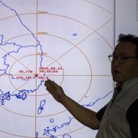 An official from the Korea Meteorological Administration explains an earthquake at the at the National Earthquake and Volcano Center of the Korea Meteorological Administration in Seoul on Monday. | AP