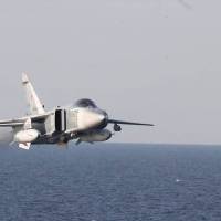 A Russian Sukhoi Su-24 attack aircraft flies over the USS Donald Cook (DDG 75), an Arleigh Burke-class guided-missile destroyer, in the Baltic Sea in April. A Russian fighter jet flew dangerously close to a U.S. spy plane over the Black Sea on Wednesday, coming within just 10 feet of the American aircraft. Russian fighter gets within 10 feet of Navy spy plane over Black Sea
