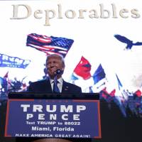 Republican U.S. presidential candidate Donald Trump smiles as he arrives to a campaign rally Friday at the James L. Knight Center in Miami. | AP
