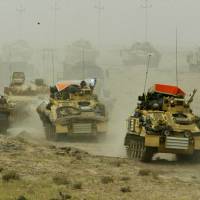 A British army armored vehicle convoy rolls into southern Iraq on March 22, 2003. | REUTERS