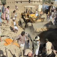 People search for victims under the rubble of houses destroyed by a Saudi-led airstrike in the northwestern city of Saada, Yemen, Wednesday. | REUTERS