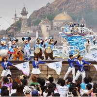 Crowds cheer at Mickey Mouse and other Disney characters during a parade at Tokyo DisneySea, the popular Disney marine theme park in Urayasu, Chiba Prefecture, on Sunday. Sunday marked the 15th anniversary of the park\'s opening. | KYODO