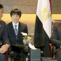 Prime Minister Shinzo Abe speaks with Egyptian President Abdel-Fattah el-Sissi in Hangzhou, China, on Sunday. | POOL / VIA KYODO