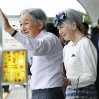 Emperor Akihito and Empress Michiko wave to the public during their recent visit to Yamagata Prefecture. | KYODO