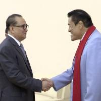 Lawmaker Kanji \"Antonio\" Inoki (right) shakes hands with Ri Su Yong, North Korea\'s vice chairman of the Central Committee of the Worker\'s Party of Korea, before their meeting in Pyongyang on Saturday. | AP