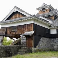 Part of Kumamoto Castle barely stands in May after the stone basement collapsed following strong earthquakes in the region the previous month. | KYODO