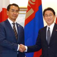 Foreign Minister Fumio Kishida (right) greets his visiting Mongolian counterpart, Tsend Munkh-Orgil, in Tokyo on Tuesday. | KYODO