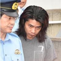 Murder suspect Dai Hiraoka is escorted from Tanashi Police Station in Nishi-Tokyo on Sunday morning. | KYODO