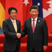 Chinese leader Xi Jinping welcomes Prime Minister Shinzo Abe to the Group of 20 summit in Hangzhou, China, on Sept. 4. | REUTERS