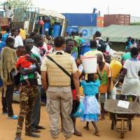Civilian evacuees gather at a U.N. peacekeeping facility in Juba on Aug. 24. Ground Self-Defense Force elements are located at the site. | KYODO