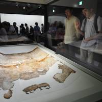 Visitors look at a celestial map from the ancient Kitora tomb, which dates from the seventh to eighth centuries, at a museum in Asuka, Nara Prefecture, on Saturday. | KYODO