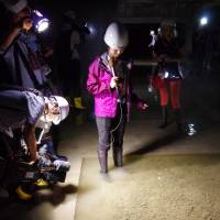 Journalists examine a flooded basement at a facility built to house the relocated Tsukiji fish market in Tokyo\'s Koto Ward on Friday. Local assembly members suspect that groundwater has welled up, potentially bringing toxic chemicals from contaminated land beneath. | REIJI YOSHIDA