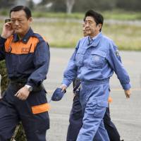 Prime Minister Shinzo Abe arrives at a Ground Self-Defense Force camp in Obihiro, Hokkaido, on Wednesday after taking a helicopter tour over the city to examine the damage caused by torrential rains brought by Typhoon Lionrock in late August. | KYODO