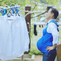 Yamaguchi Gov. Tsugumasa Muraoka wears a so-called pregnancy vest in this screen shot from the video \"The Governor is a Pregnant Woman.\" | REUTERS