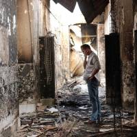 Hospitals as targets: An employee of Medecins Sans Frontieres walks inside the charred remains of the organization’s hospital in Kunduz, Afghanistan, weeks after the building was hit by a U.S. airstrike on Oct. 3, 2015, killing 42 people. Medecins Sans Frontieres Japan calls for end to deadly attacks on hospitals