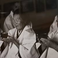 Old rituals: Okinawan priestesses called noro (above, in a print found in a Naha bookstore) have been an integral part of life on Kudaka Island. | STEPHEN MANSFIELD