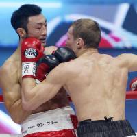 Russia\'s Eduard Troyanovsky punches challenger Keita Obara during their IBF light welterweight title bout in Moscow on Friday. | AP/VIA KYODO