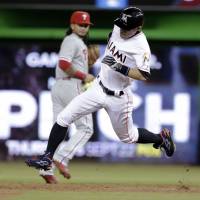 Miami’s Ichiro Suzuki rounds second base on a triple during the first inning of the Marlins’ 6-0 win over the Phillies on Wednesday. Ichiro passes Palmeiro, climbs to 26th on MLB all-time hit list