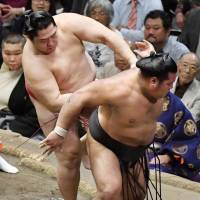 Endo shoves Shohozan out of the raised ring on Friday at the Autumn Grand Sumo Tournament. Endo improved to 11-2. | KYODO