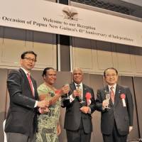 Papua New Guinea\'s Ambassador Gabriel JK Dusava (second from right) and his wife Anna prepare to toast with Deputy Director-General, Ministry of Foreign Affairs Asian and Oceanian Affairs Bureau Noriyuki Shikata (left) and Chairman of the Japan-Papua New Guinea Parliamentarian\'s Friendship League Kazunori Tanaka  during a reception celebrating the country\'s 41st Anniversary of Independence at the Marriott Hotel in Tokyo on Sept. 16. | YOSHIAKI MIURA