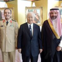 Saudi Arabia\'s Ambassador Ahmad Younos S. Al Barrak (right) and military attache Col. Khalid bin Mohammed Abdullah Al-takhais (left) welcome Hiromasa Yonekura (center), chairman of the Japan-Saudi Arabia Society, during a reception to celebrate the country\'s 86th National Day at the Palace Hotel Tokyo on Sept. 26. | TAKUTO MINAMI