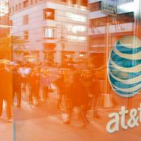 An AT&amp;T store is seen on 5th Avenue in New York on Sunday. AT&amp;T unveiled a mega-deal for Time Warner that would transform the telecom giant into a media-entertainment powerhouse positioned for a sector facing major technology changes. The stock-and-cash deal is valued at &#36;108.7 billion, including debt, and gives a value of &#36;84.5 billion to Time Warner &#8212; a major name in the sector that includes the Warner Bros. studios in Hollywood and an array of TV assets such as HBO and CNN. | AFP-JIJI