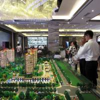 Models of residential buildings are seen at a sales center in Zhengzhou, in China\'s Henan province, on Sept. 23. | REUTERS