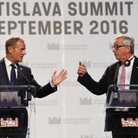 European Council President Donald Tusk (left) and European Commission President Jean Claude Juncker hold a news conference at the end of an EU summit in Bratislava in September. | REUTERS / KYODO