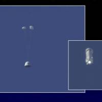 In this image made from video provided by Blue Origin, the New Shepard capsule (left) prepares to return to the ground as its booster rocket continues upward during a test of the escape system in west Texas on Wednesday. The escape system is designed to save lives if something goes wrong with the rocket during liftoff. Blue Origin capsule stages successful escape after launch, rocket lands upright