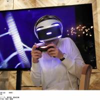 A woman tries out the product at the company’s showroom in Tokyo.  | AFP-JIJI