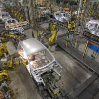 Robots work on the bodywork of a Nissan Qashqai automobile at the production plant in Sunderland, Britain, in 2010. | BLOOMBERG