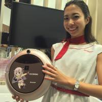 A model for Sharp Corp. shows off the electronics maker’s latest vacuum cleaner featuring the Vocaloid singing voice synthesizer software at the ongoing CEATEC electronics trade show in the city of Chiba on Wednesday. Sharp's singing vacuum aims to tug users' heart strings