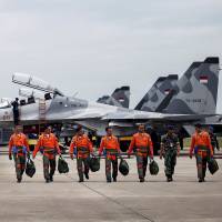 Indonesian Air Force Sukhoi fighter pilots and crew walk across the tarmac after training for an upcoming military exercise at Hang Nadim Airport, Batam, Riau Islands, Indonesia, on Monday. | ANTARA FOTO / VIA REUTERS